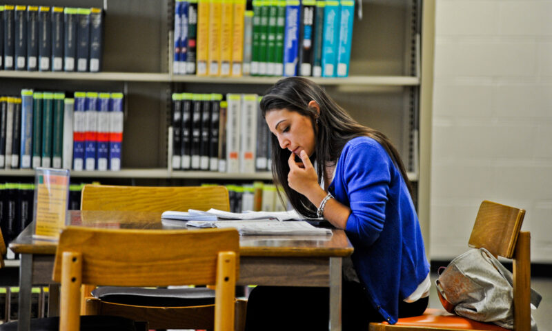 Female Caucasian student studying in the library